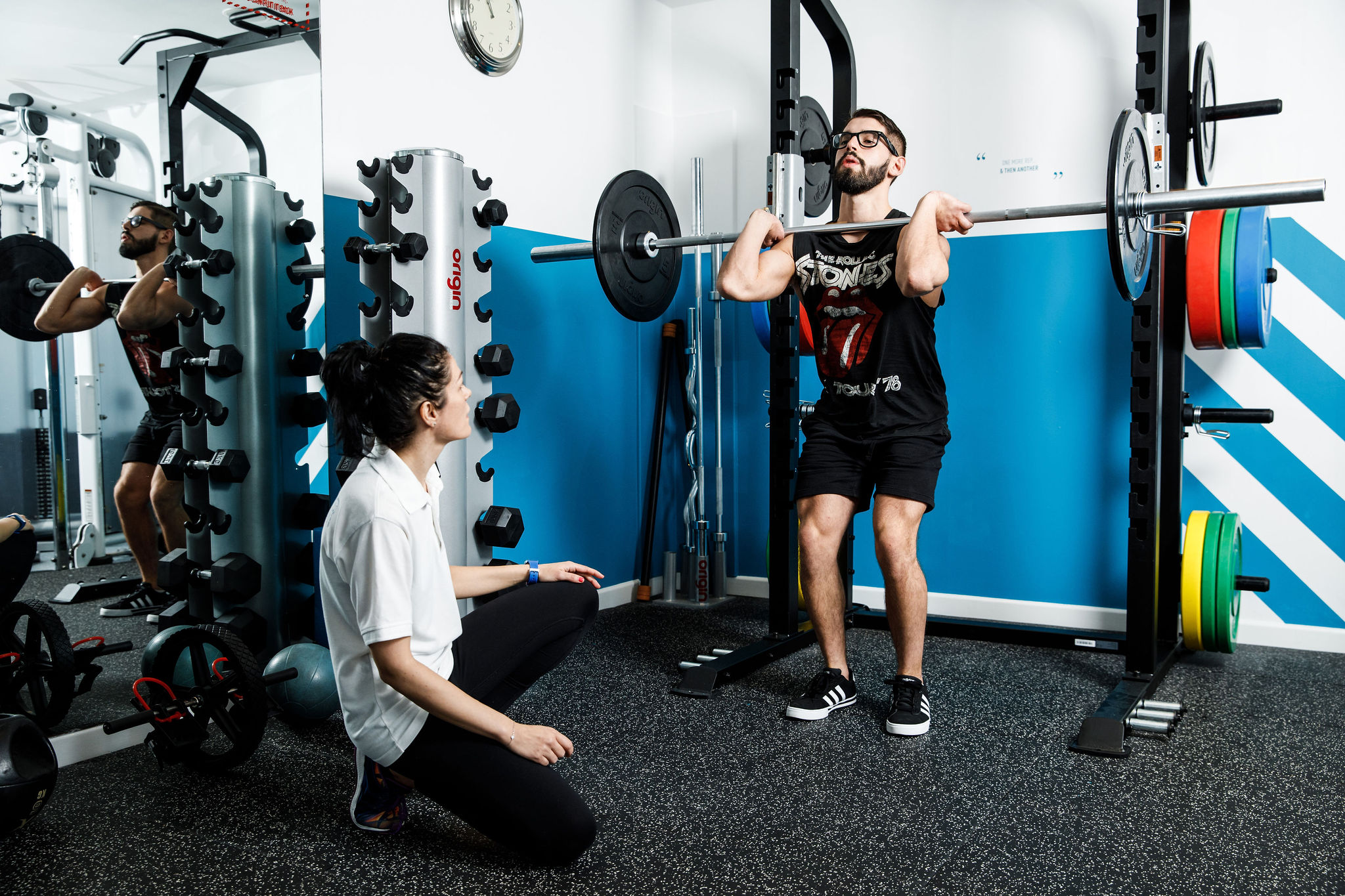 Man gets instructed how to use weights at Merton Leisure Club